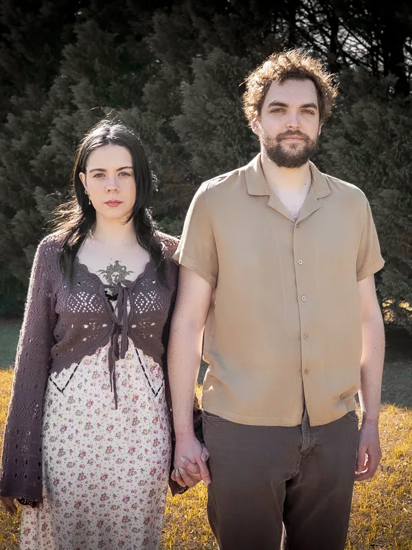 Jacob and Vicki holding hands in an autumn field