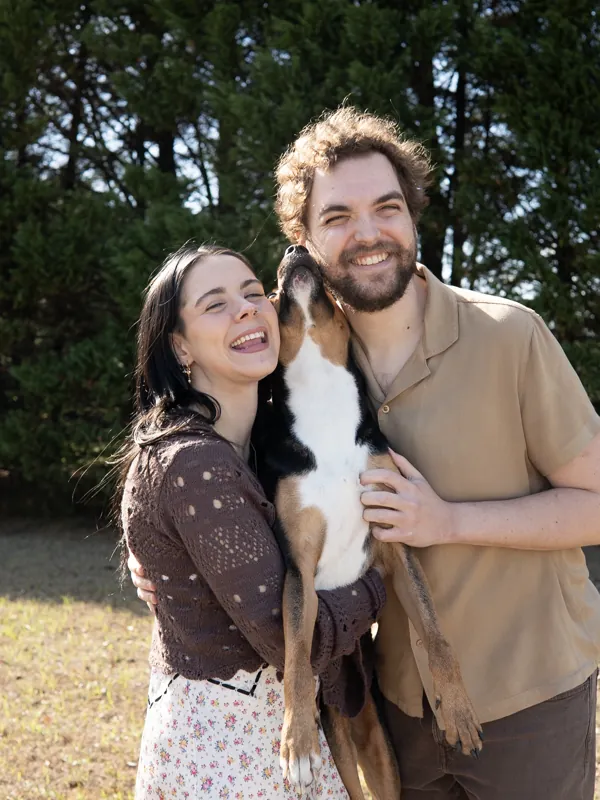 Jacob and Vicki outdoors holding their cat between them